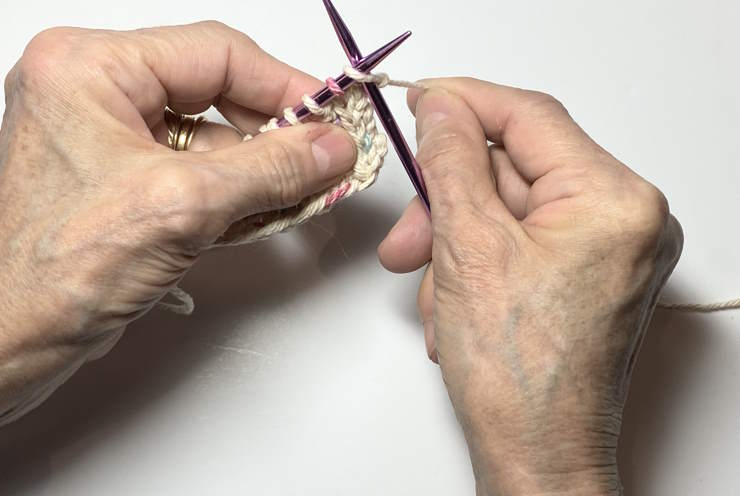 Demonstration of how to knit through the front loop of a stitch. Demonstration of how to knit through the front loop of a stitch.
