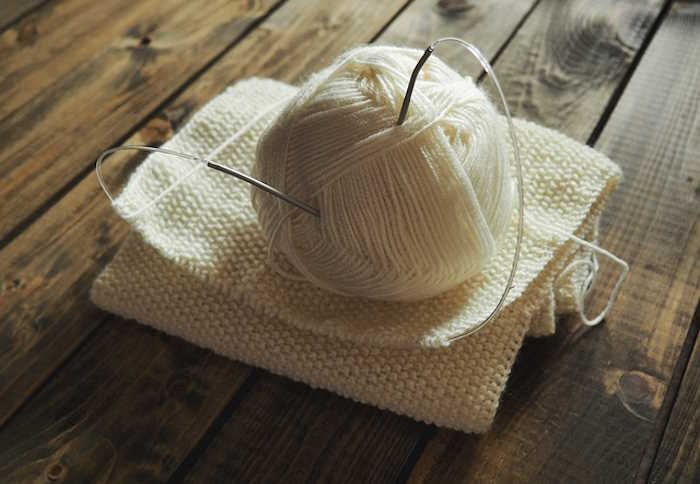 A knitted sample with yarn and circular knitting needles A knitted sample with yarn and circular knitting needles