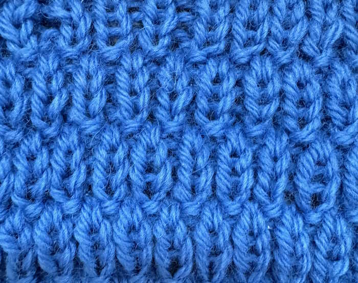 Swatch in blue of the long raindrop knit stitch pattern Swatch in blue of the long raindrop knit stitch pattern