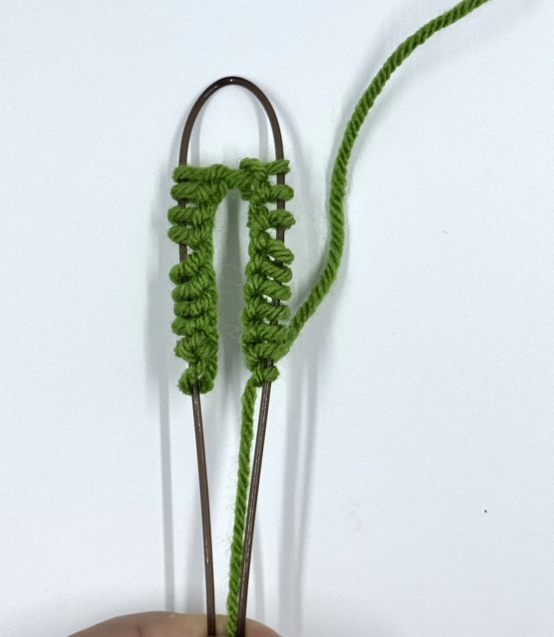 Next,  bend the cable in half with half of the stitches on either side of the bend.