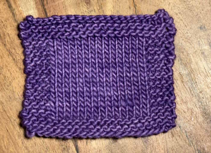 A knitted swatch of Malabrigoyarn in colorways cuarzo, worsted weight wool