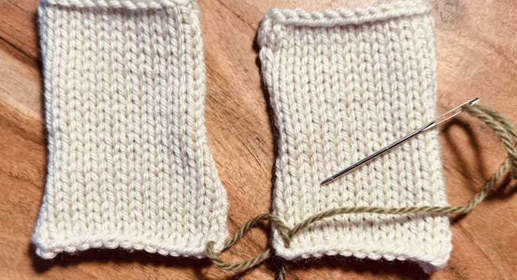 Two stockinette stitch pattern swatches are being sewn together with the mattress stitch
