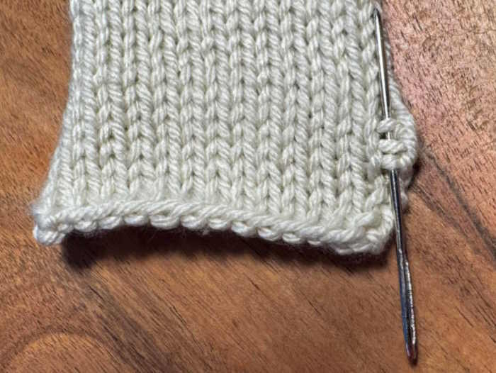 To make the mattress stitch, locate the little bars between the column of stitches or little Vs