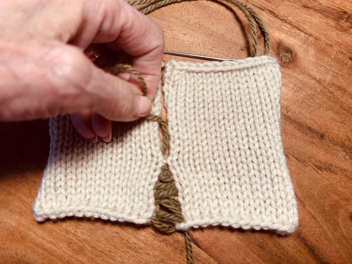 The mattress stitch has been worked and now is being tightened manually