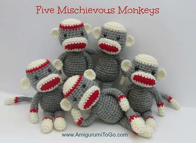 A collection of sock monkeys crocheted in gray yarn