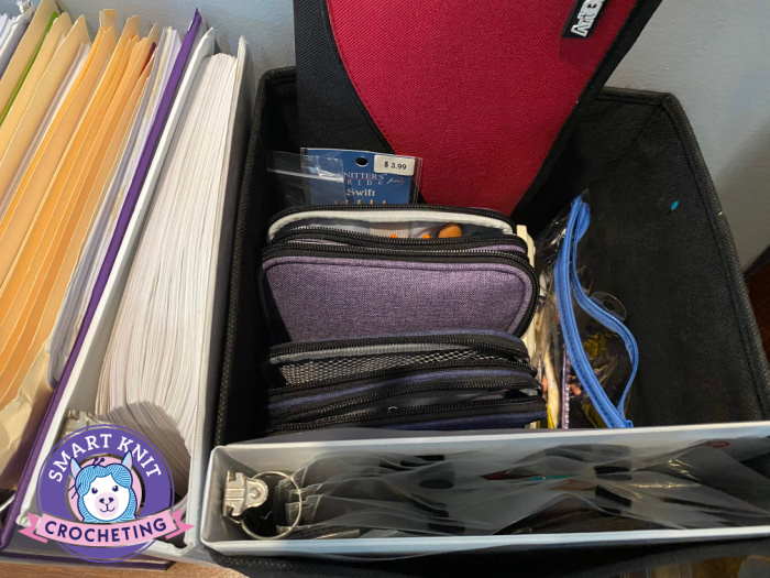knitting needles are placed in a case and then put in a cube along with crochet hooks