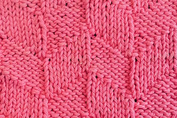 Parallogram knit stitch worked in pink in a thumbnail photo