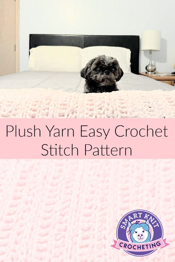A plush yarn crochet blanket is folded at the end of a bed with a Shih Tzu dog resting on top.