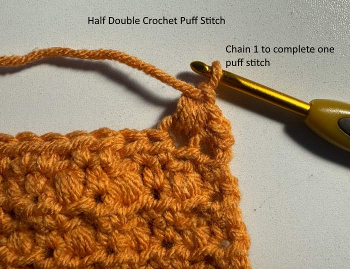 Complete the half double crochet puff stitch with one chain stitch. Complete the half double crochet puff stitch with one chain stitch.