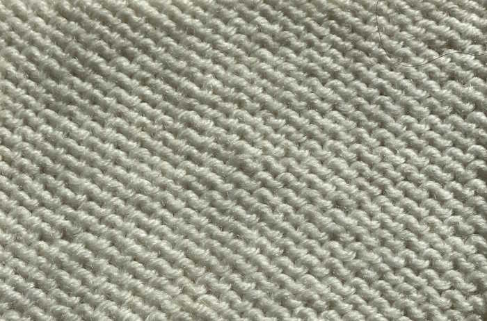The Purl Stitch Purl stitch swatch also known as reverse stockinette worked in white yarn
