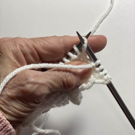 Step-by-step tutorial on making the purl stitch.  Step one is shown Step-by-step tutorial on making the purl stitch.  Step one is shown