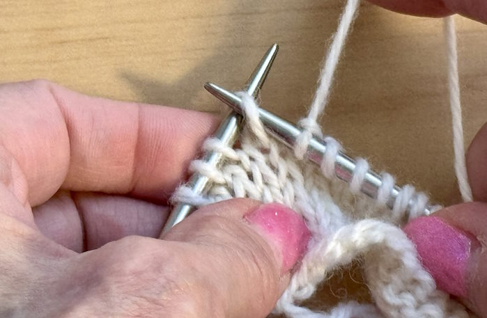 How to Make a Purl Stitch Demonstrating where to insert the needle to make a purl stitch