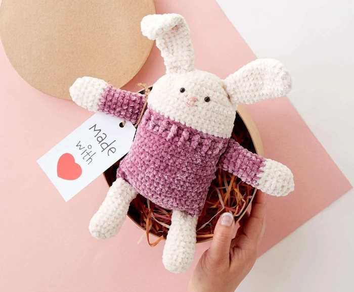 A rabbit crocheted toy in white and purple