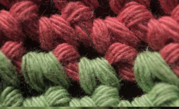 red and green yarn worked in a crochet stitch red and green yarn worked in a crochet stitch