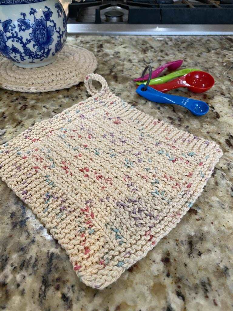 Knitted rice stitch dishcloth or facecloth shown on a kitchen counter