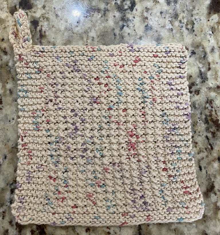 Flat photo of the knitted rice stitch dishcloth