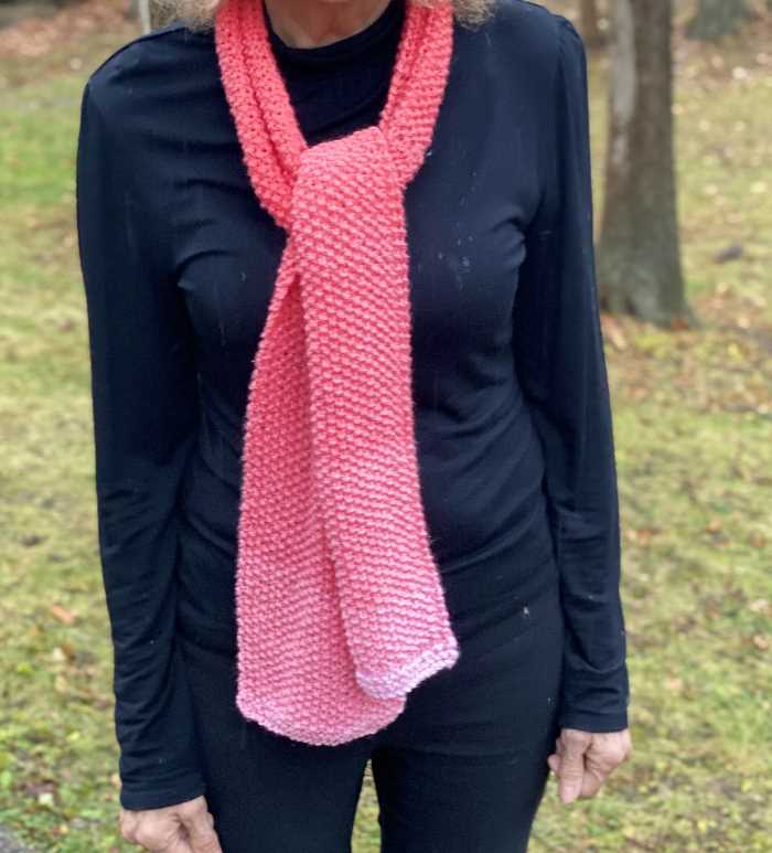 seed stitch knit scarf worn by a woman seed stitch knit scarf worn by a woman