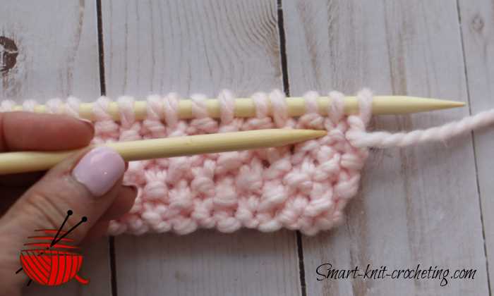 seed-stitch-knit pointing out a knit stitch in the fabric seed-stitch-knit pointing out a knit stitch in the fabric