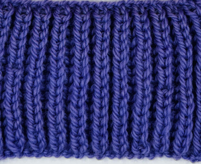 Wrong side is showin of a swatch worked with the Shaker Rib Stitch Pattern