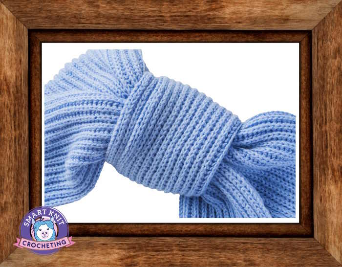 A knit product placed in wooden frame for showcasing