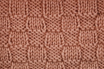 Simple Checker is a decorative pattern that uses just knit and purl stitches and is also reversible