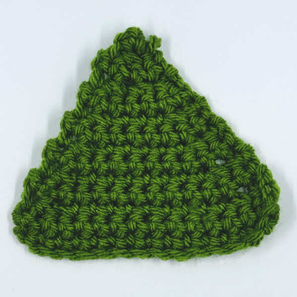 A triangular shaped swatch of single crochet showing how decreases might appear. A triangular shaped swatch of single crochet showing how decreases might appear.