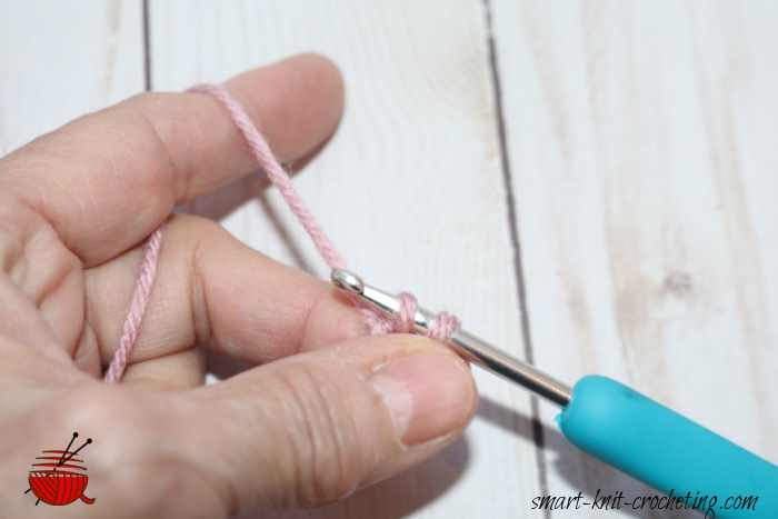 Yarn over demonstrated in making the single crochet