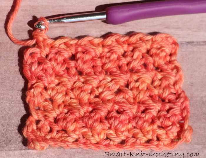 Single Double Crochet grit stitch worked in orange variegated number 4 merino wool.