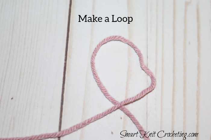 To make a slip knot, first, make a loop with the yarn. To make a slip knot, first, make a loop with the yarn.