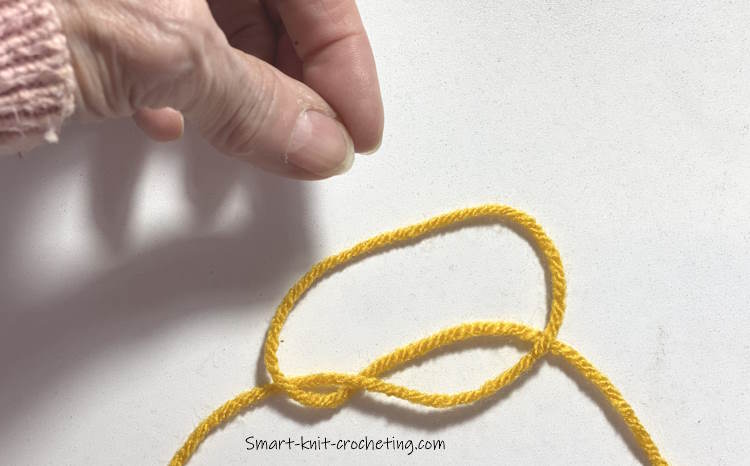 A slip knot on the table is almost complete
