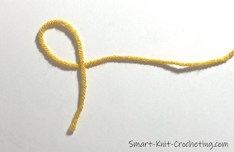 Step one of a pictorial tutorial on how to make the slip knot