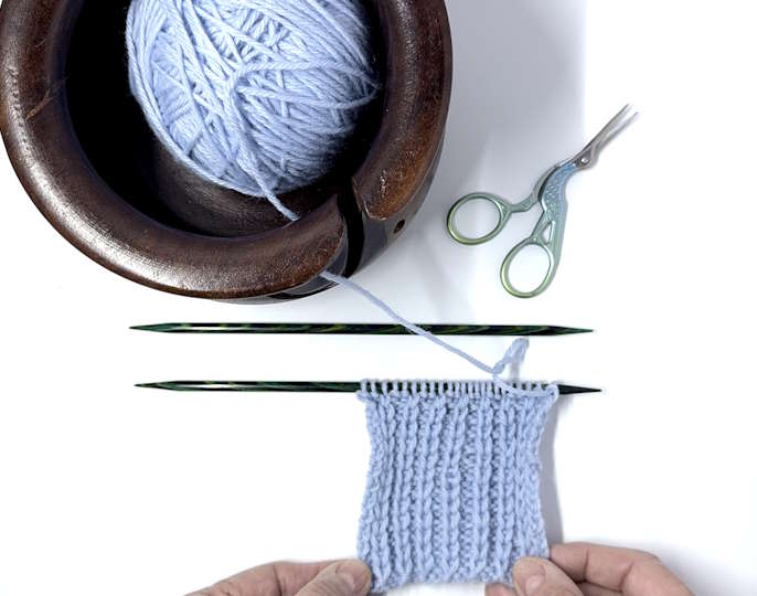 slip stitch rib pattern worked in blue yarn and still on the needles
