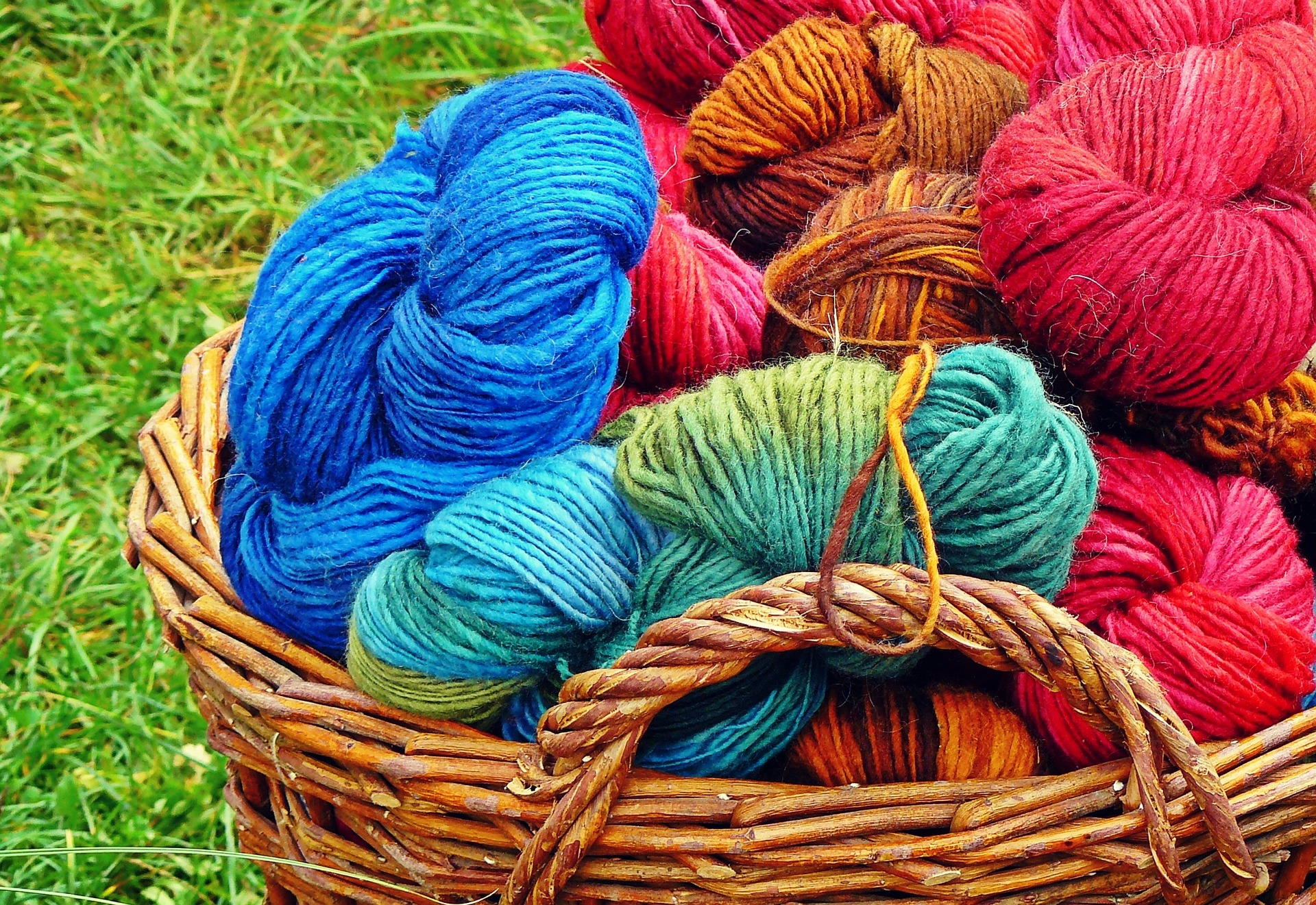 A basket of different colored yarns A basket of different colored yarns