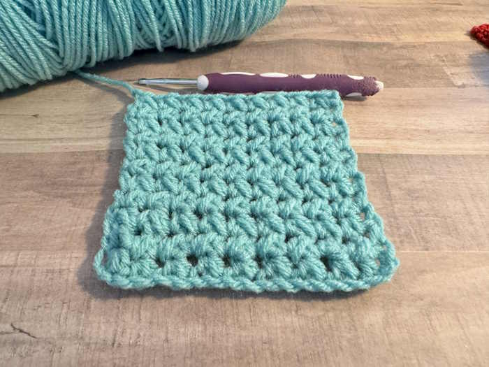 The staggered half-double crochet stitch in blue teal 100% acrylic yarn.