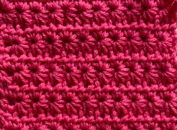 crochet star stitch worked in bright pink acrylic yarn.