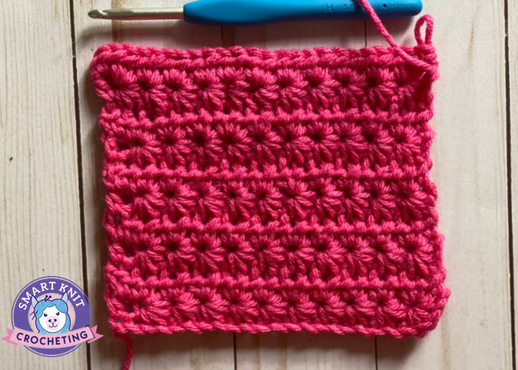 crochet star stitch worked in bright pink acrylic yarn.