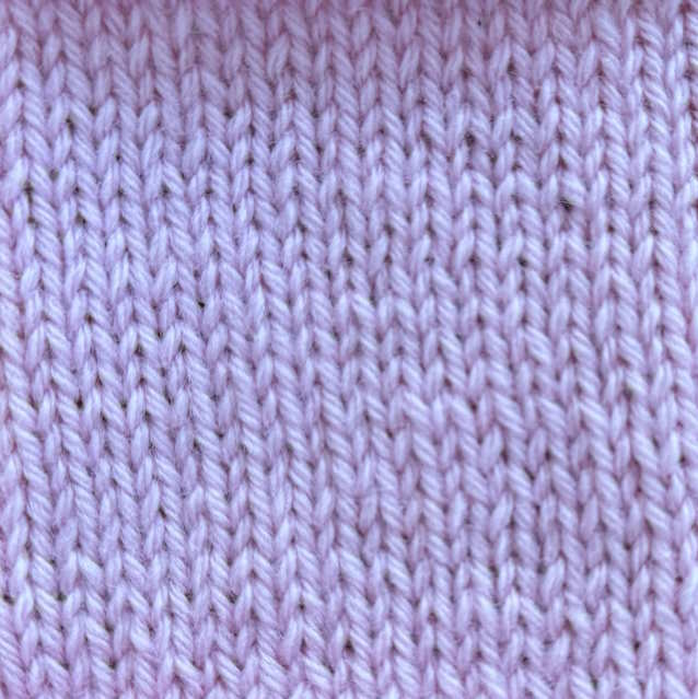 A knitted swatch of stockinette pattern worked in pink wool A knitted swatch of stockinette pattern worked in pink wool