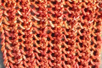 Straight lace knit swatch worked in orange yarn (thumbnail)