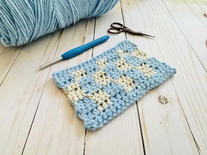 A swatch of tapestry crochet worked in blue and white acrylic yarn