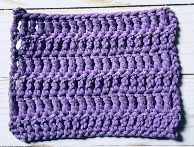 A swatch of treble crochet worked in purple.