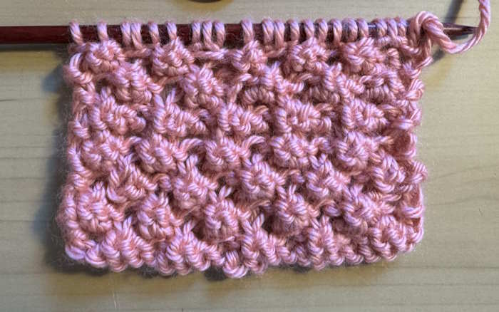 The right side is showing of the Trinity or Rasberry knit stitch pattern
