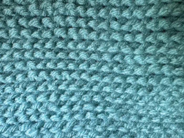 Swatch of the tunisian knit stitch showing the wrong side