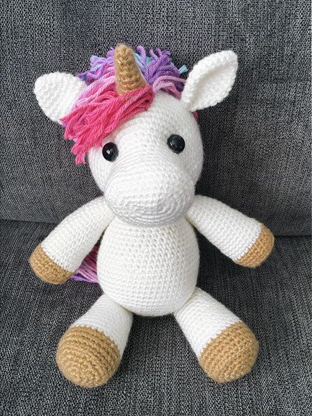 A colorful unicorn toy is crocheted