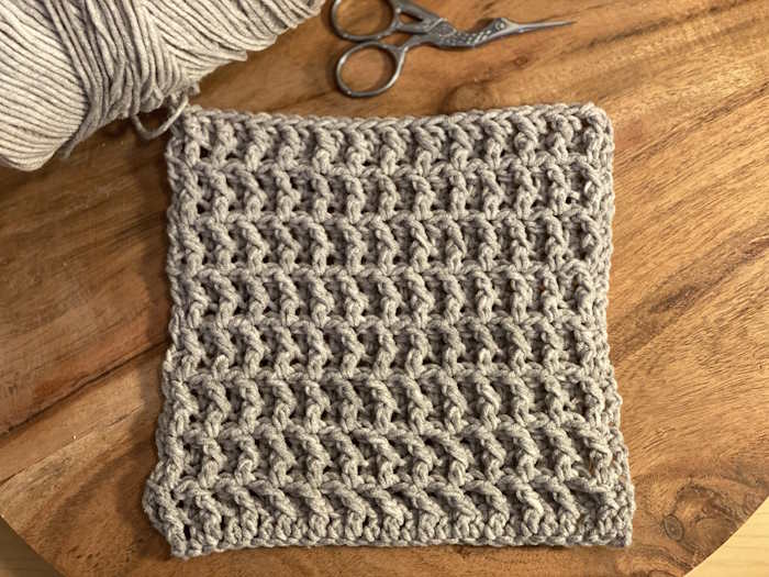 Crochet waffle stitch pattern worked in gray cotton and acrylic yarn
