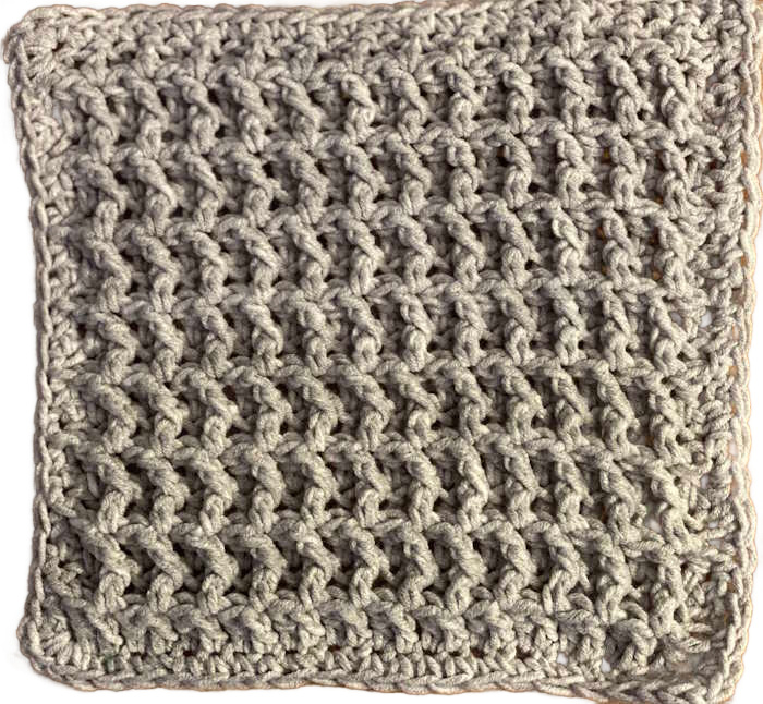 Waffle crochet stitch dishcloth shown with a single crochet border