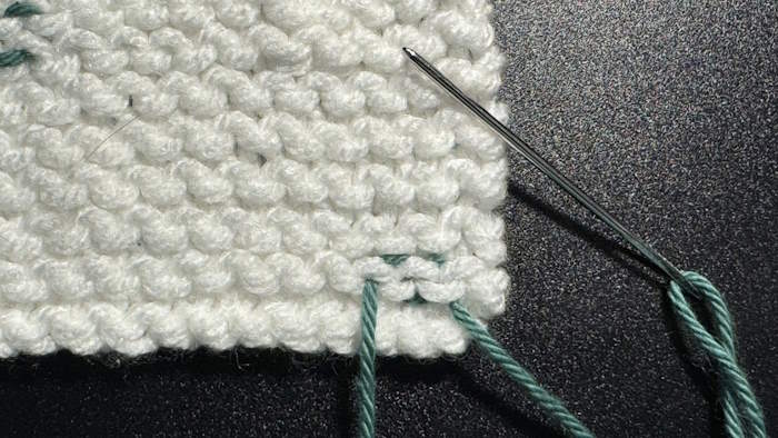 Shown is how to weave in ends in the garter stitch pattern
