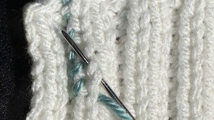 Step by step tutorial for weaving in ends in ribbing showing a technique that is not visible on the right side.