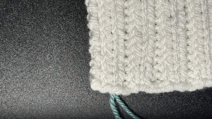 Weaving in ends in ribbing showing how it appears on the right side