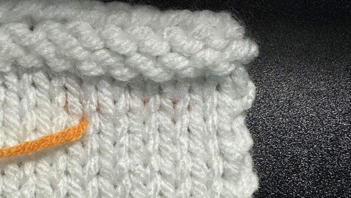 The right side is showing of the duplicate stitch method for weaving in ends in stockinette stitch.