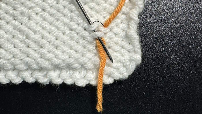 Step two for weaving in ends in stockinette stitch showing how this step is completed